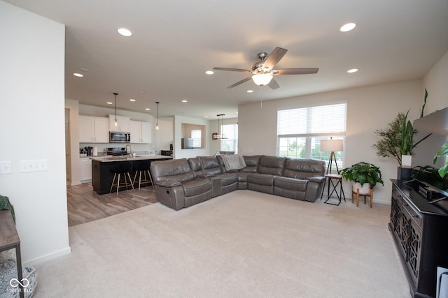 6748 Fallen Leaf Dr, Whitestown, IN 46075 - living area featuring light colored carpet, a ceiling fan, recessed lighting, and baseboards