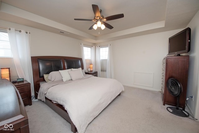 6748 Fallen Leaf Dr, Whitestown, IN 46075 - bedroom featuring a tray ceiling, light carpet, and ceiling fan