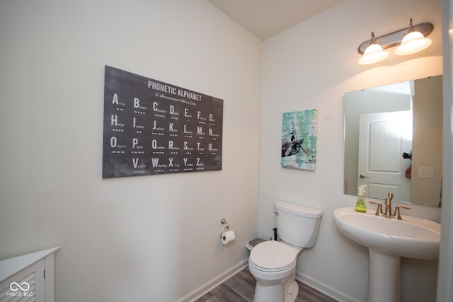 6748 Fallen Leaf Dr, Whitestown, IN 46075 - bathroom with toilet, wood finished floors, and baseboards
