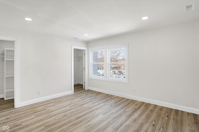 empty room with light hardwood / wood-style floors