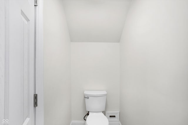 bathroom with toilet and vaulted ceiling