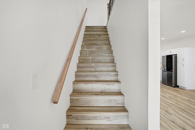 staircase with hardwood / wood-style floors