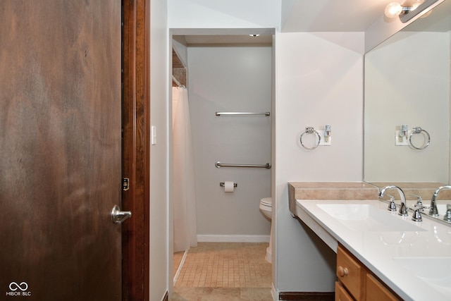 bathroom featuring tile patterned floors, vanity, and toilet