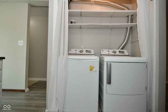 laundry area with wood-type flooring and washer and clothes dryer