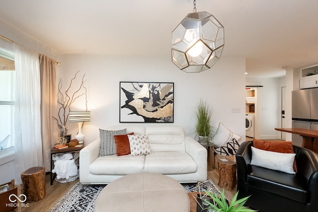 living room featuring washer / clothes dryer and hardwood / wood-style floors