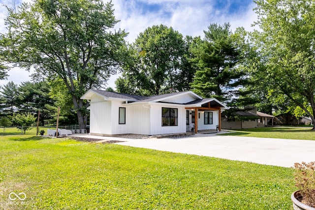 modern farmhouse style home with a front yard