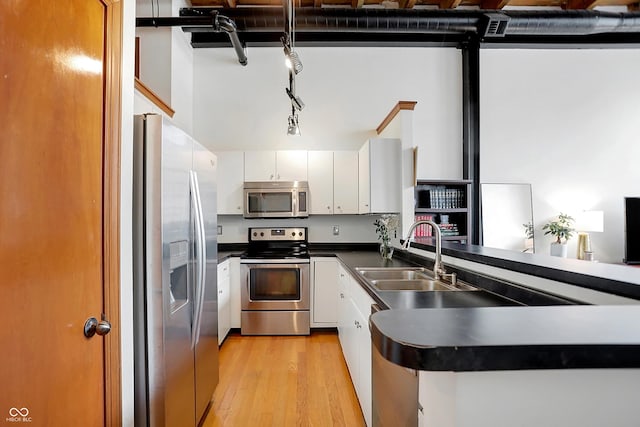 kitchen with sink, light hardwood / wood-style flooring, stainless steel appliances, and white cabinets