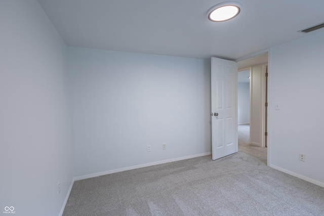 unfurnished room with baseboards, visible vents, and carpet flooring