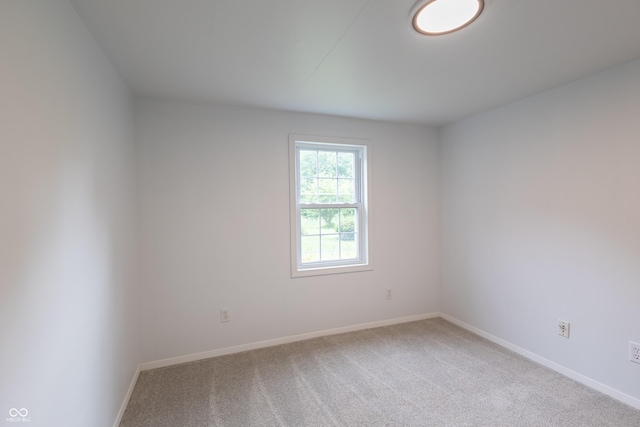 carpeted empty room with baseboards