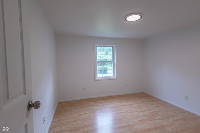 unfurnished room featuring light wood-style flooring and baseboards