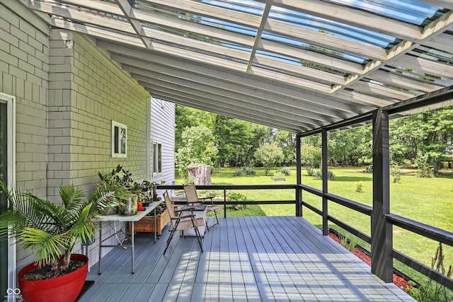 wooden terrace with a lawn