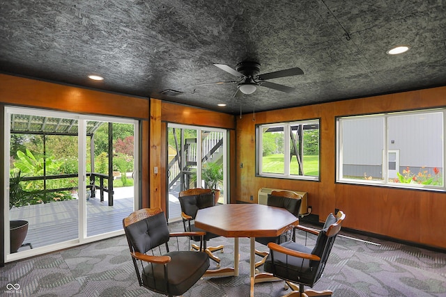 sunroom / solarium featuring a ceiling fan and a wealth of natural light