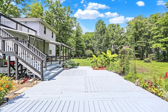 wooden deck featuring a yard and stairway