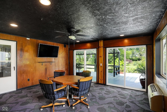 dining area with a wall mounted AC, a ceiling fan, wood walls, dark carpet, and recessed lighting