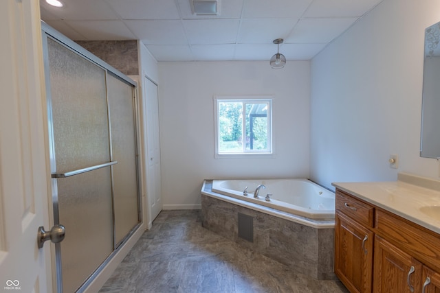 bathroom with a drop ceiling, a garden tub, visible vents, vanity, and a shower stall