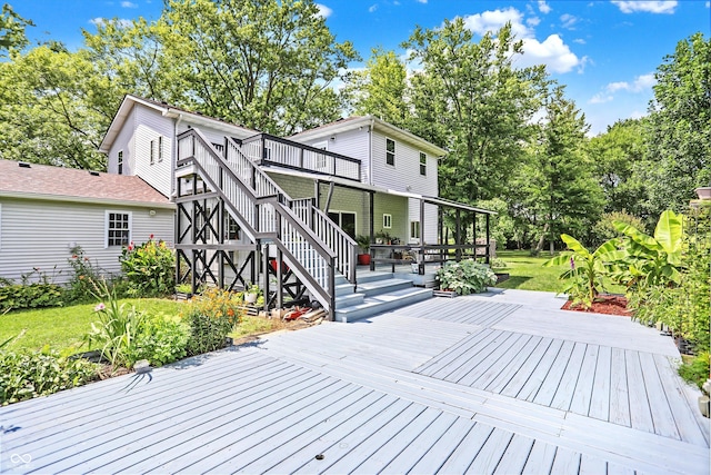 wooden terrace with stairs and a yard