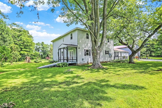 view of front of house featuring a front yard and a wooden deck