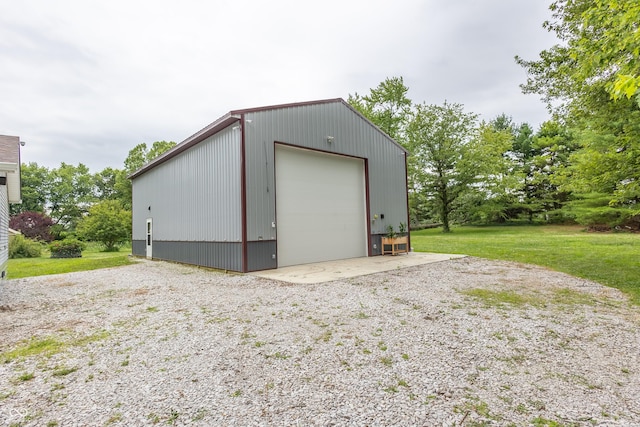 detached garage with gravel driveway