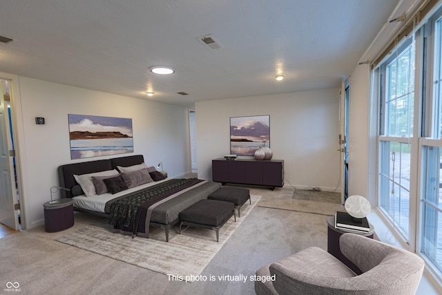 carpeted bedroom featuring visible vents and baseboards