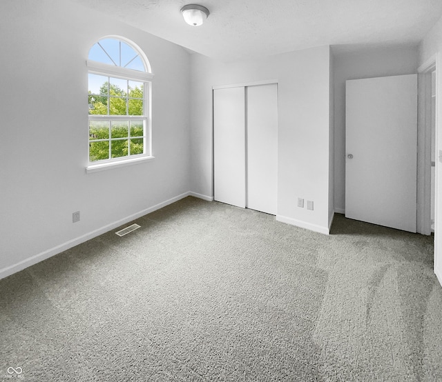 unfurnished bedroom featuring a closet and carpet floors