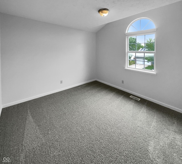 carpeted spare room with a textured ceiling