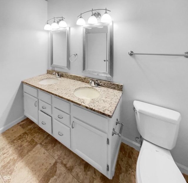 bathroom featuring toilet and vanity