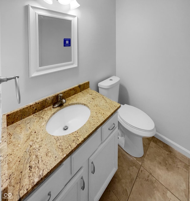 bathroom with tile patterned flooring, vanity, and toilet