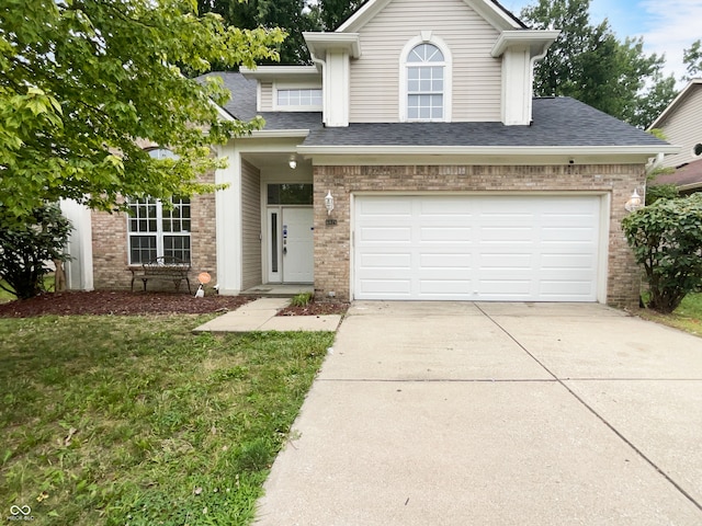 view of front of property featuring a front lawn and a garage