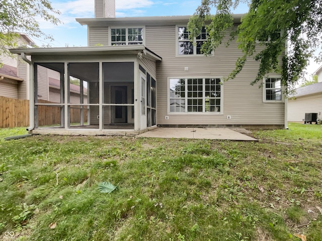 rear view of house with a patio area, central AC unit, a lawn, and a sunroom