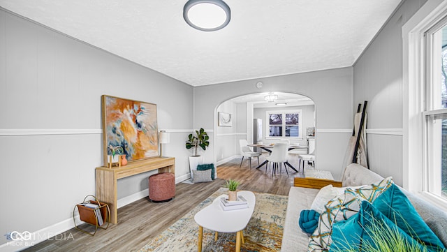 living room featuring wood-type flooring and a textured ceiling