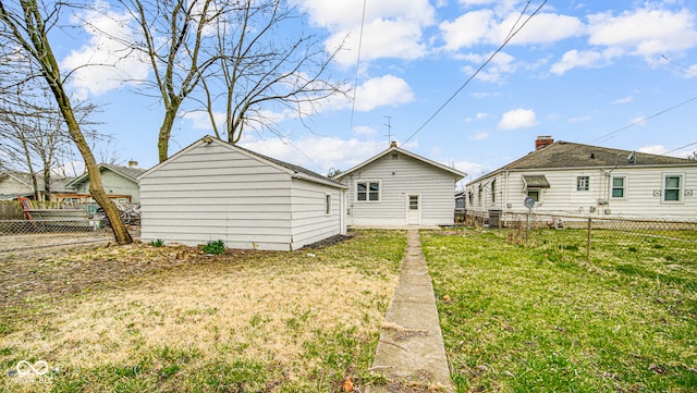 back of property featuring a lawn