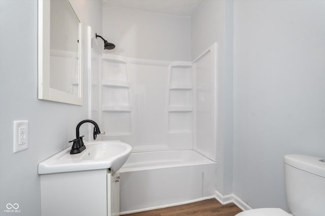 full bathroom with toilet, bathing tub / shower combination, hardwood / wood-style floors, and vanity