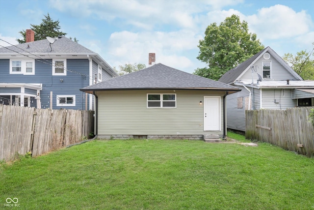 back of house featuring a yard