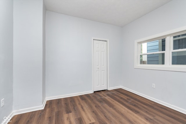 unfurnished room featuring dark hardwood / wood-style floors