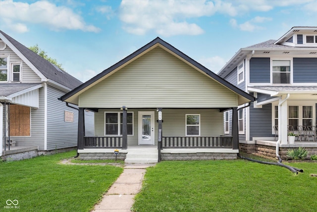 bungalow with a front lawn and covered porch