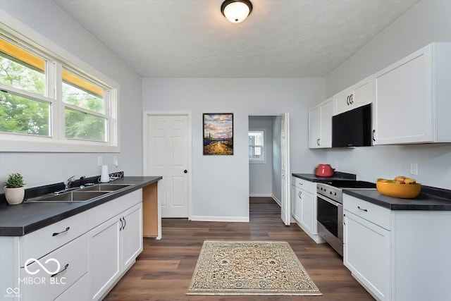 kitchen with dark wood-type flooring, sink, white cabinetry, and stainless steel range with electric stovetop