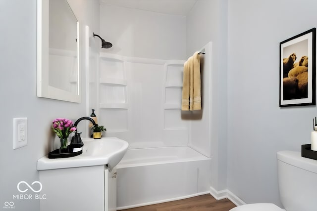 full bathroom with shower / bathing tub combination, hardwood / wood-style floors, toilet, and vanity