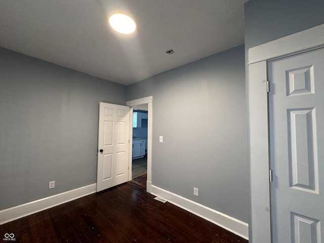 unfurnished room featuring dark hardwood / wood-style flooring