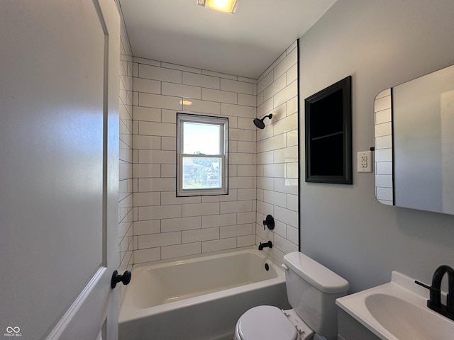 full bathroom featuring tiled shower / bath combo, vanity, and toilet