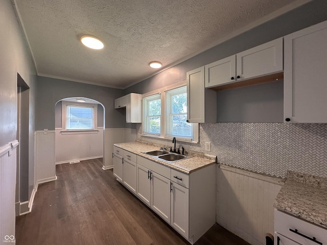 kitchen with a textured ceiling, white cabinetry, dark hardwood / wood-style floors, and sink