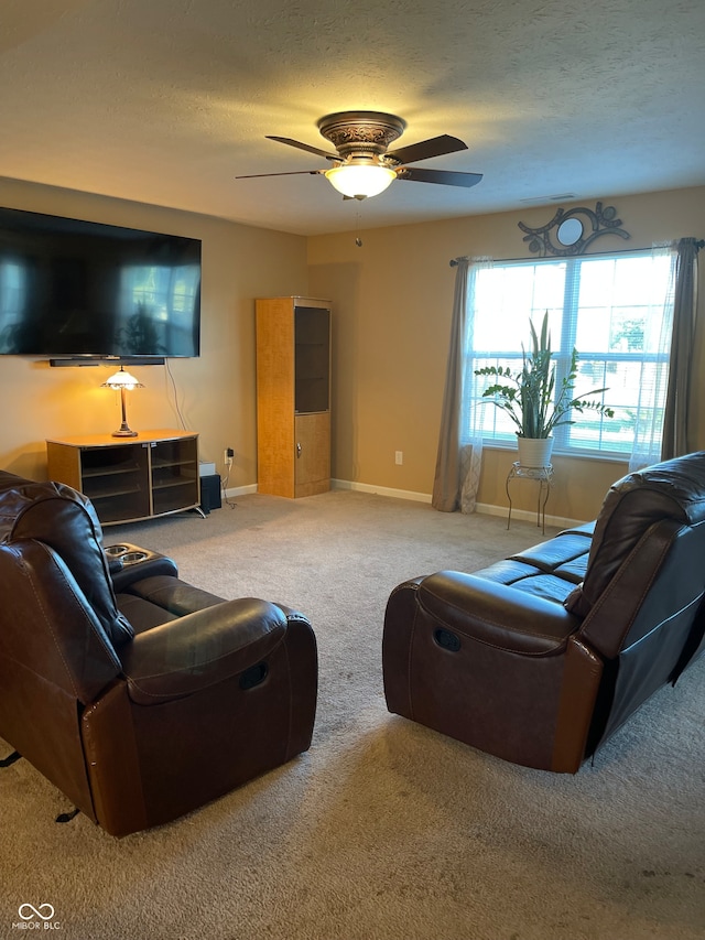 carpeted living room with ceiling fan