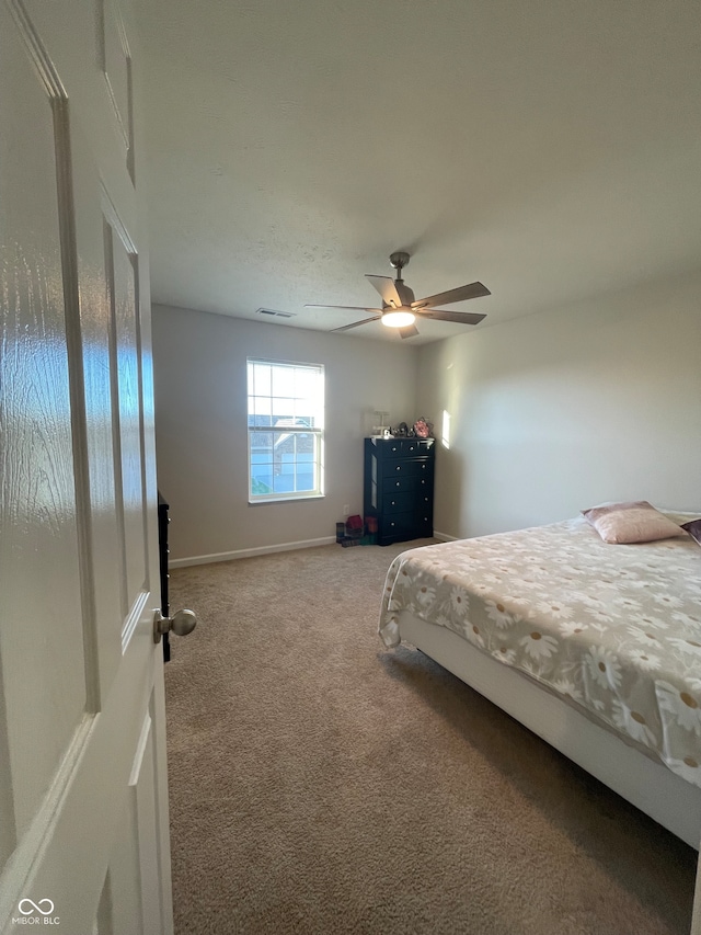 carpeted bedroom with ceiling fan