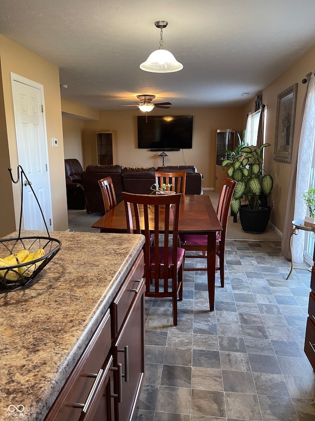 tiled dining space featuring ceiling fan