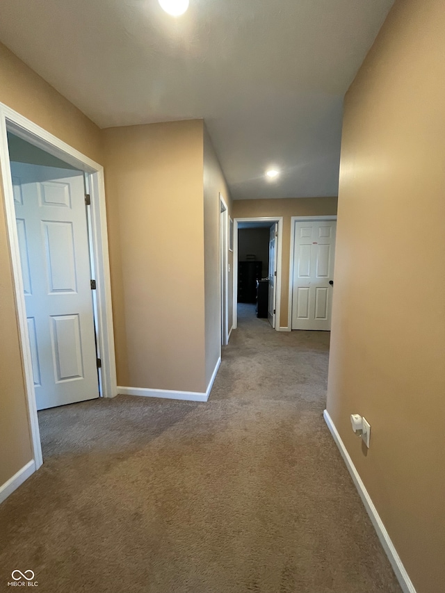 hall with light colored carpet