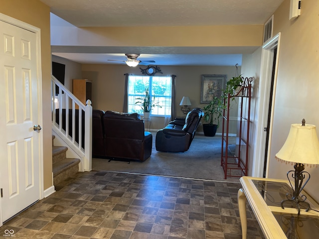 carpeted living room with ceiling fan