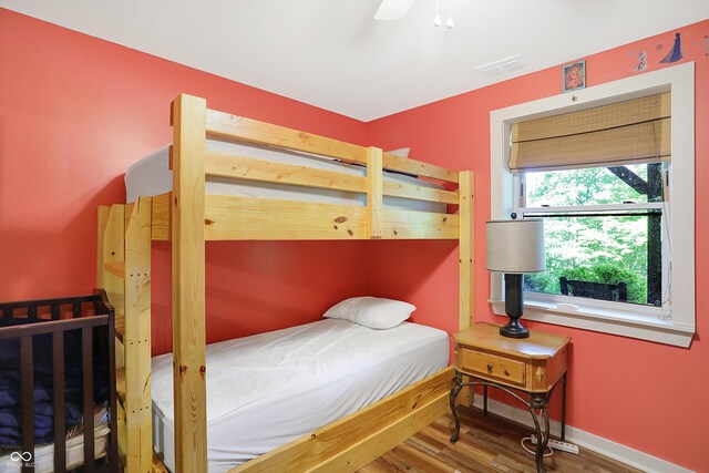 bedroom with ceiling fan and hardwood / wood-style flooring