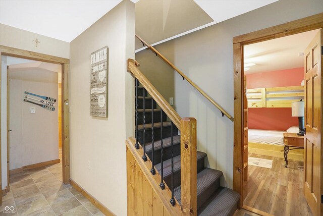 stairway featuring light tile patterned flooring