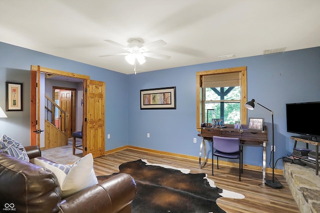 living room with ceiling fan and hardwood / wood-style flooring