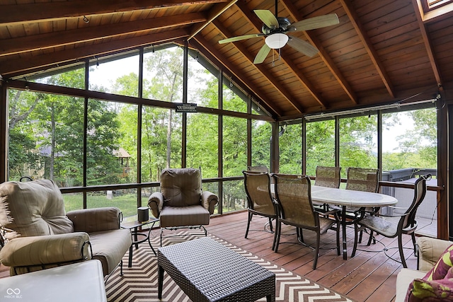 unfurnished sunroom with wooden ceiling, ceiling fan, vaulted ceiling with beams, and plenty of natural light