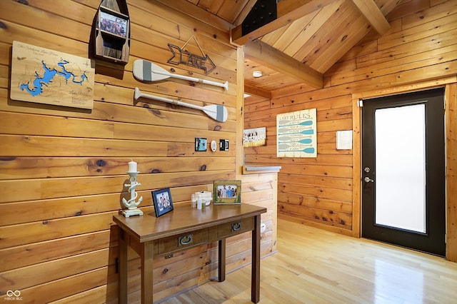 office with lofted ceiling with beams, wood walls, light wood-type flooring, and wooden ceiling